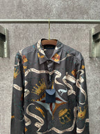 Long-sleeve button-up shirt in dark blue with colorful graphic scarf-style print.