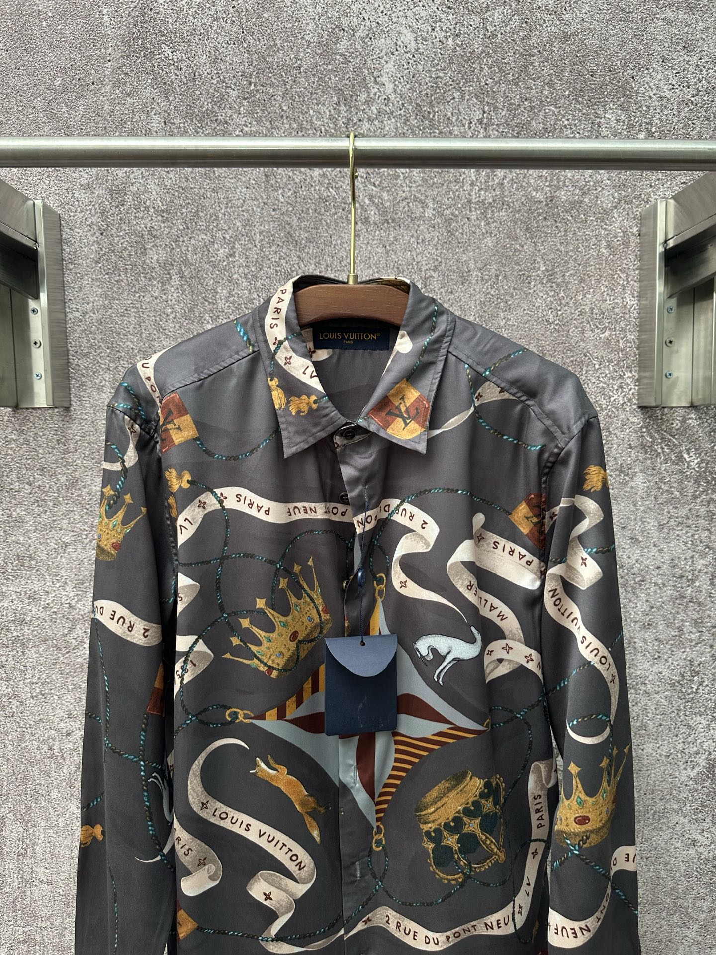 Long-sleeve button-up shirt in dark blue with colorful graphic scarf-style print.