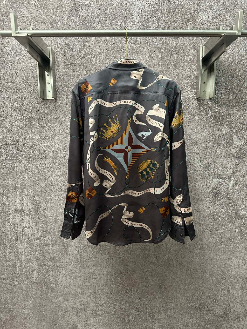 Long-sleeve button-up shirt in dark blue with all-over chain, animal, and rope pattern.