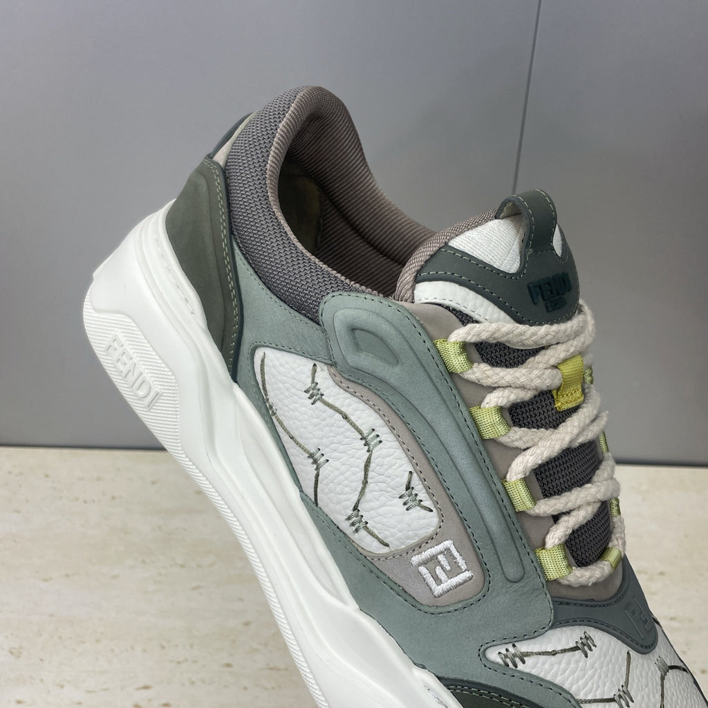 Fendi unisex sneakers, close-up side profile with patterned panels and lime-green lace accents