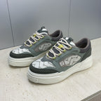 Fendi unisex sneakers, front three-quarter view with patterned toe and lime-green lace trim