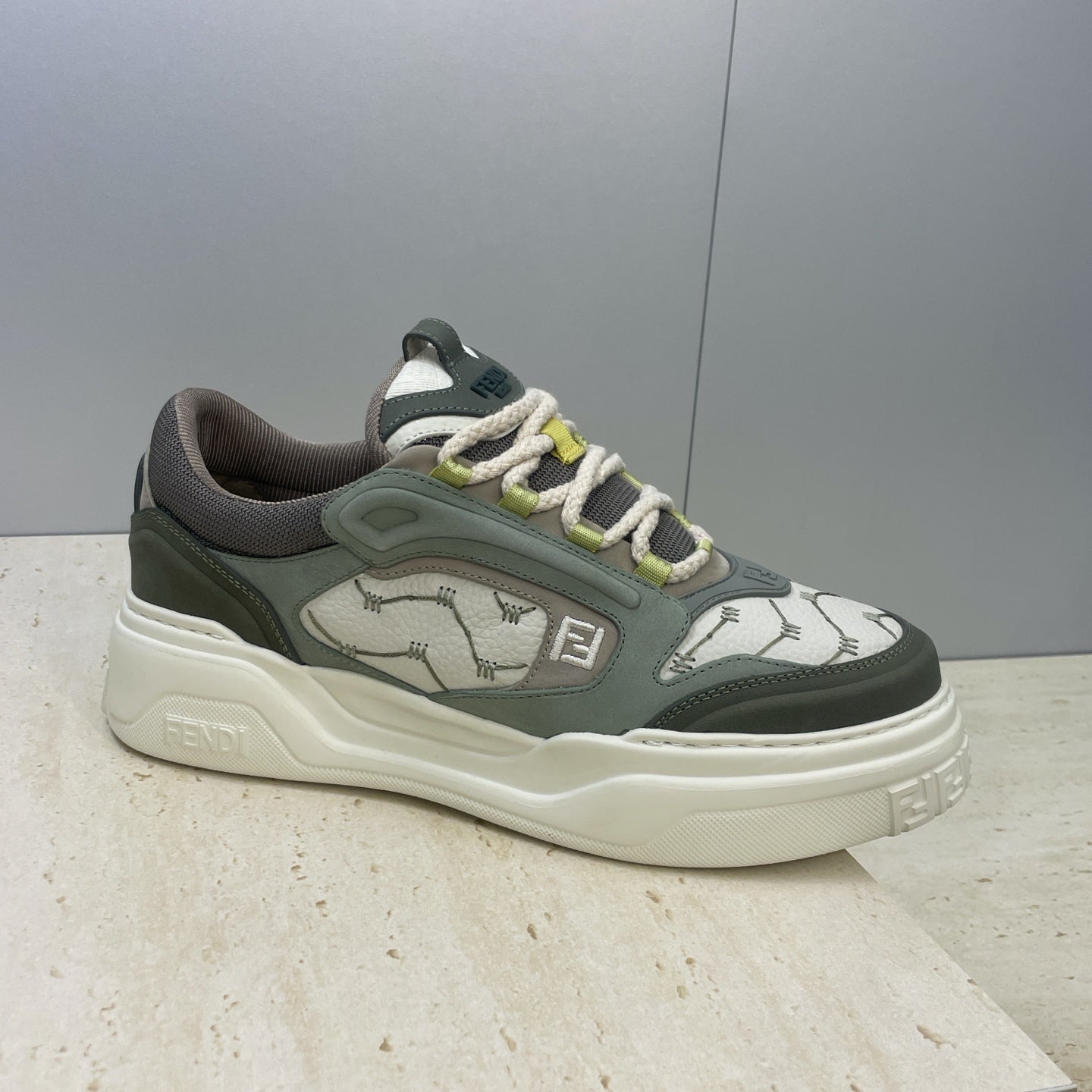 Fendi unisex sneakers, single side view with patterned uppers and lime-green lace accents