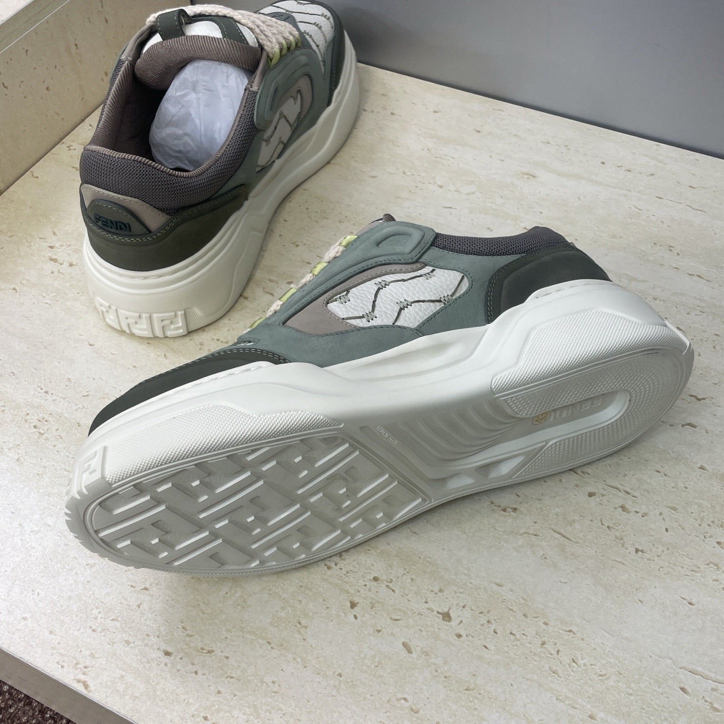 Fendi unisex sneakers, heel and outsole view with textured tread and dark upper