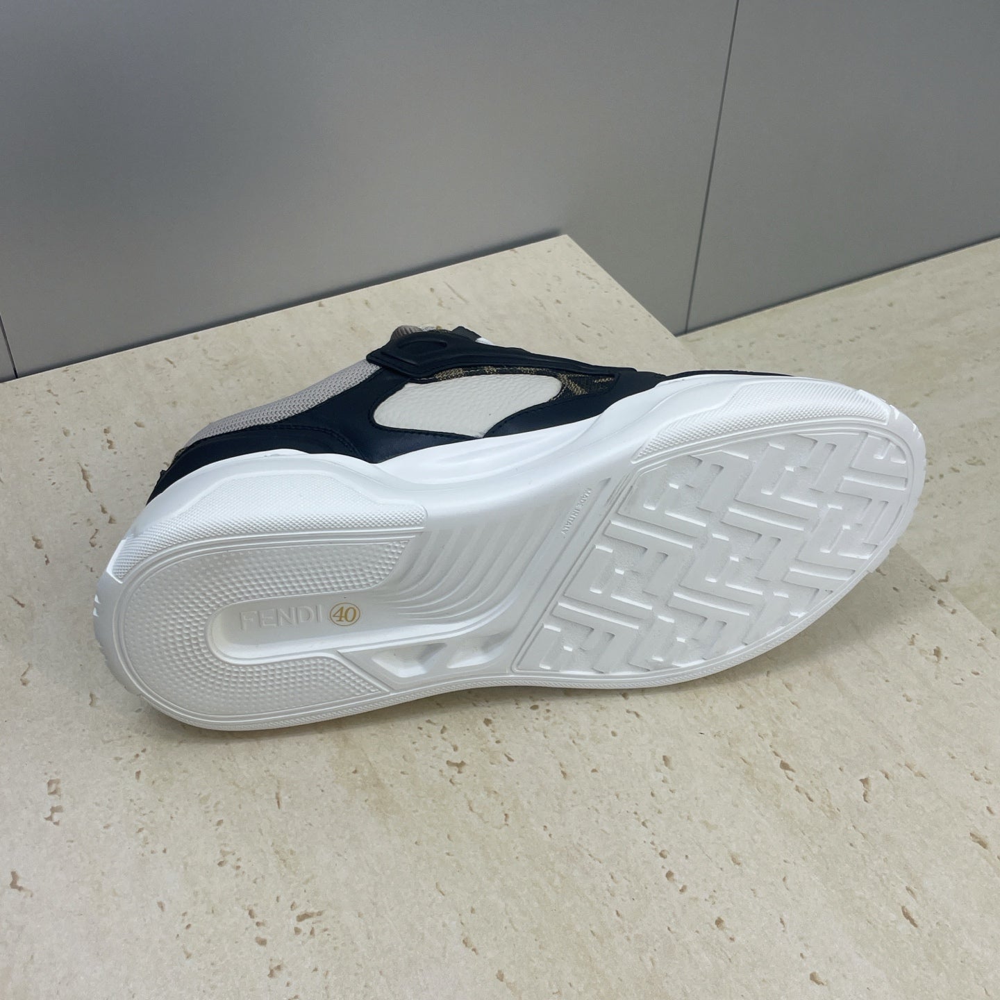 Fendi unisex sneakers outsole view, thick white sole with tread pattern and branding