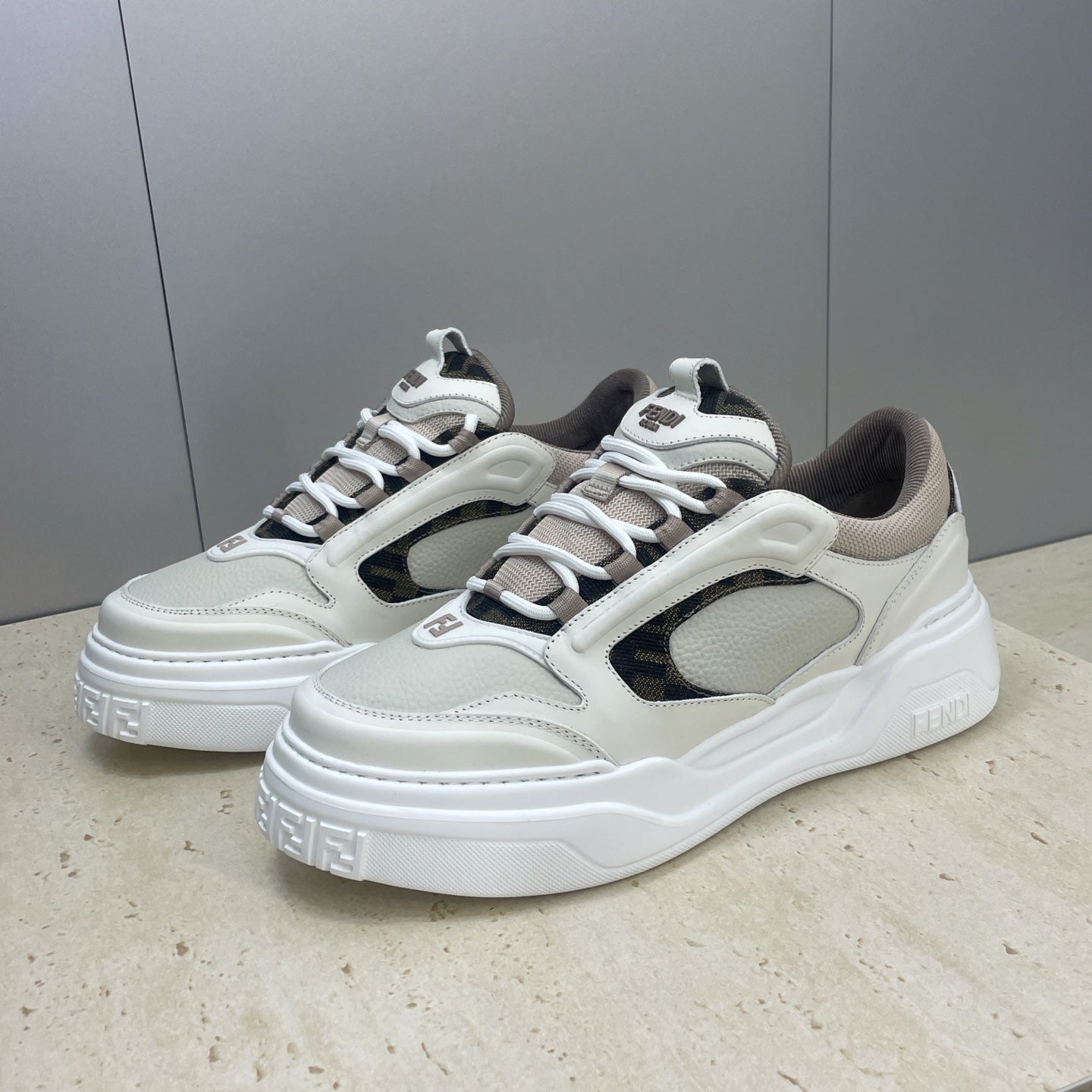 Fendi unisex low-top sneakers in white with dark inserts, lace-up styling and embossed logos.