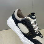 Fendi unisex sneaker close-up: navy and off-white upper with strap detail and laces