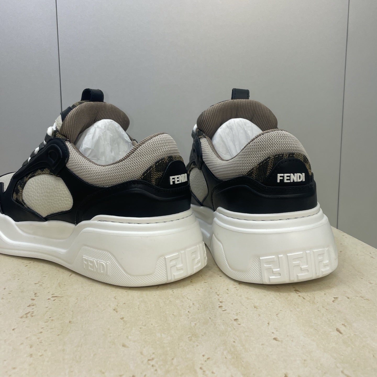 Fendi unisex sneakers rear view in navy and off-white with Fendi logo on heel