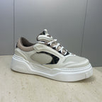 Fendi unisex sneakers side view: white upper, dark oval side panel, lace-up and platform sole.