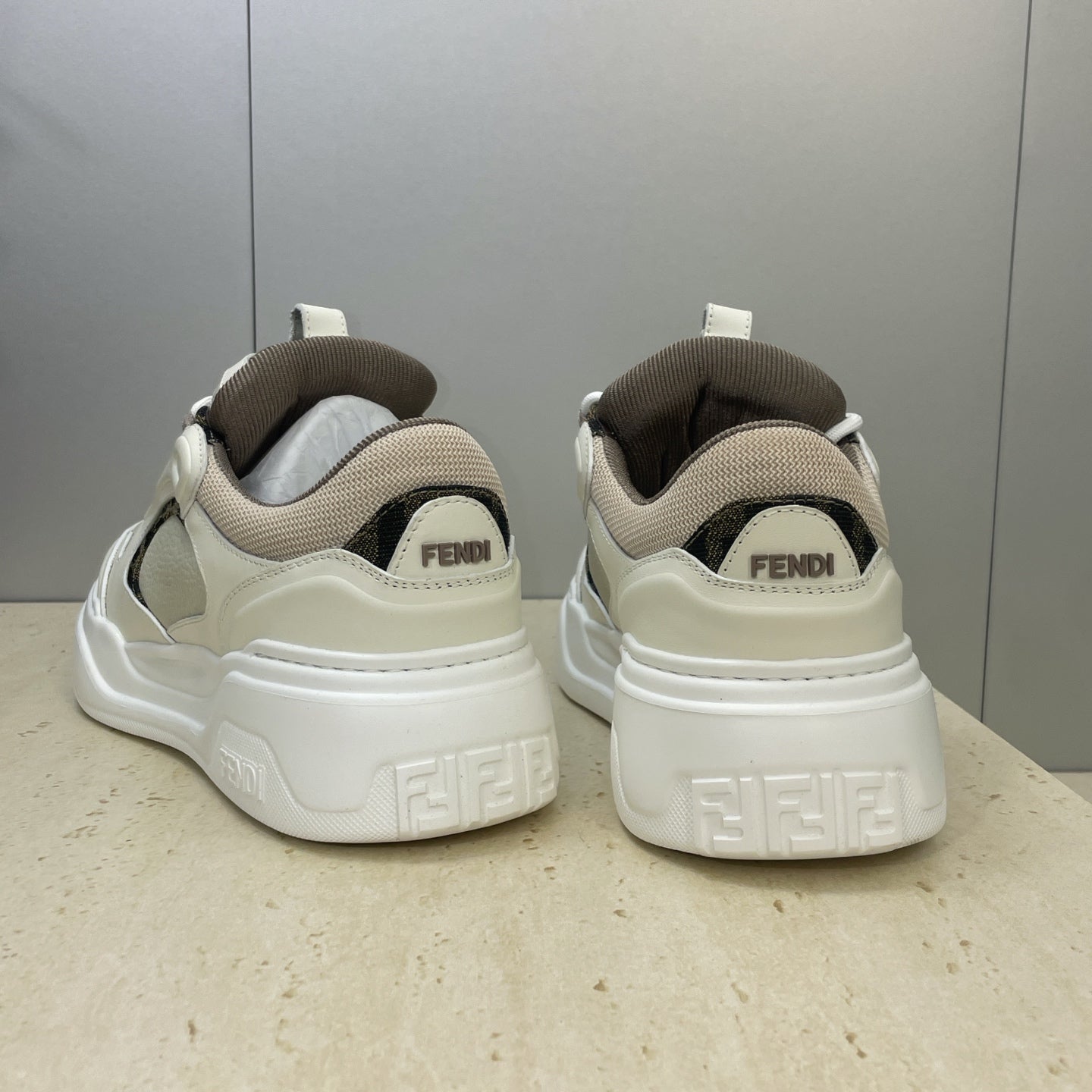 Fendi unisex sneakers back view: white heel tabs, Fendi branding, and chunky tread sole.