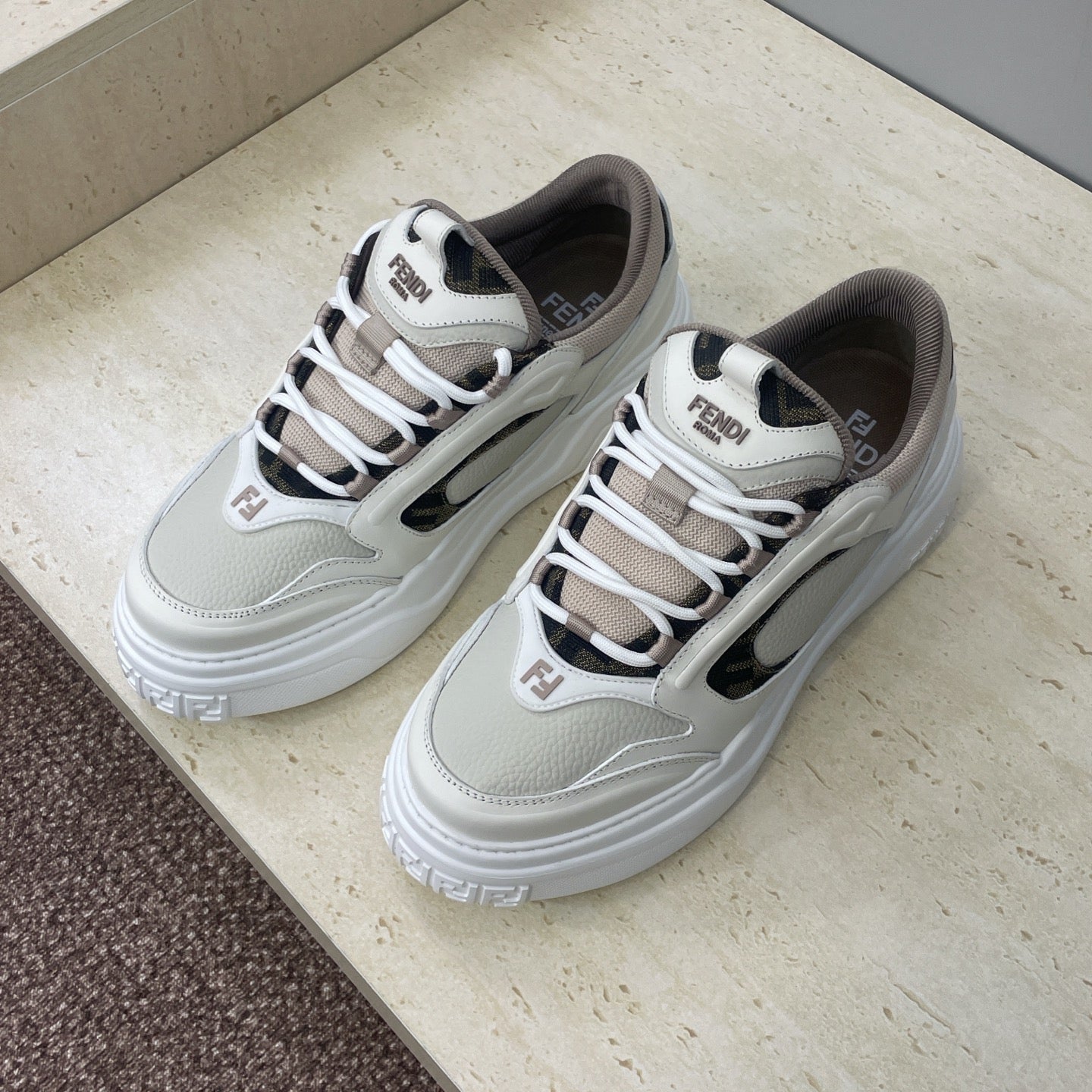 Fendi unisex sneakers, white leather look with dark side panel, lace-up design and chunky sole.