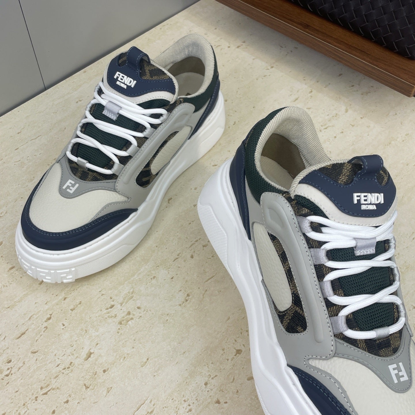 Fendi unisex sneakers front view: light gray leather with navy toe guard and laces