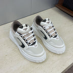 Fendi unisex lace-up sneakers with white uppers, dark swoosh-like panels, and rubber platform sole.