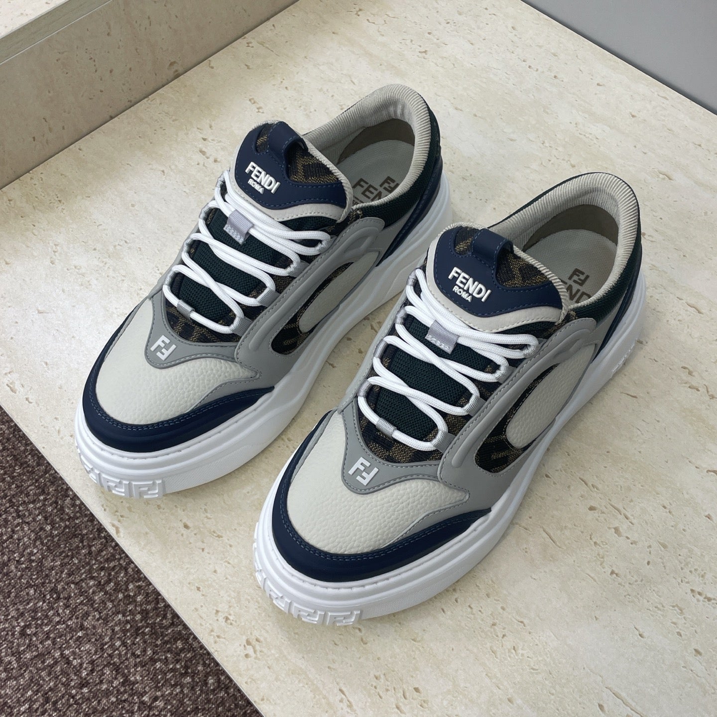 Fendi unisex sneakers with white laces, navy panels, and chunky white sole