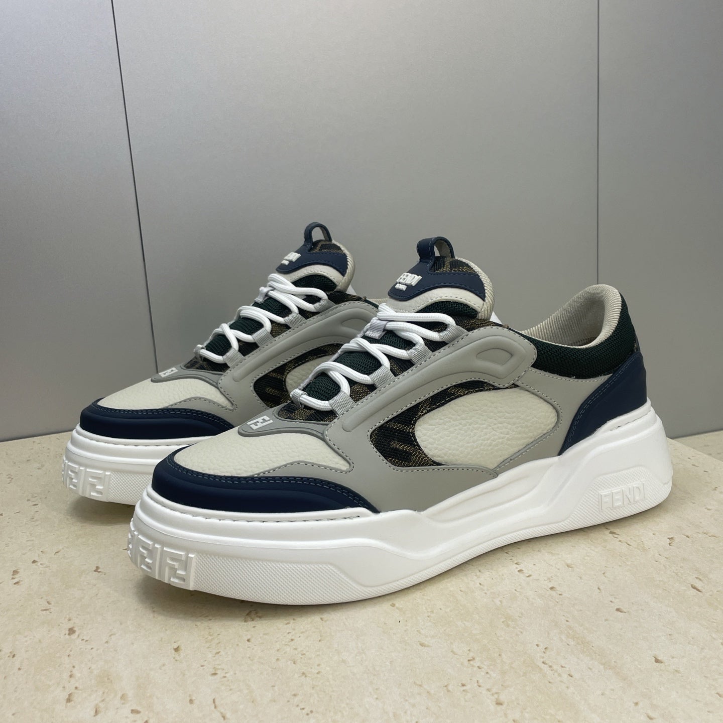 Fendi unisex sneakers side view: beige-gray upper with navy trim and white midsole