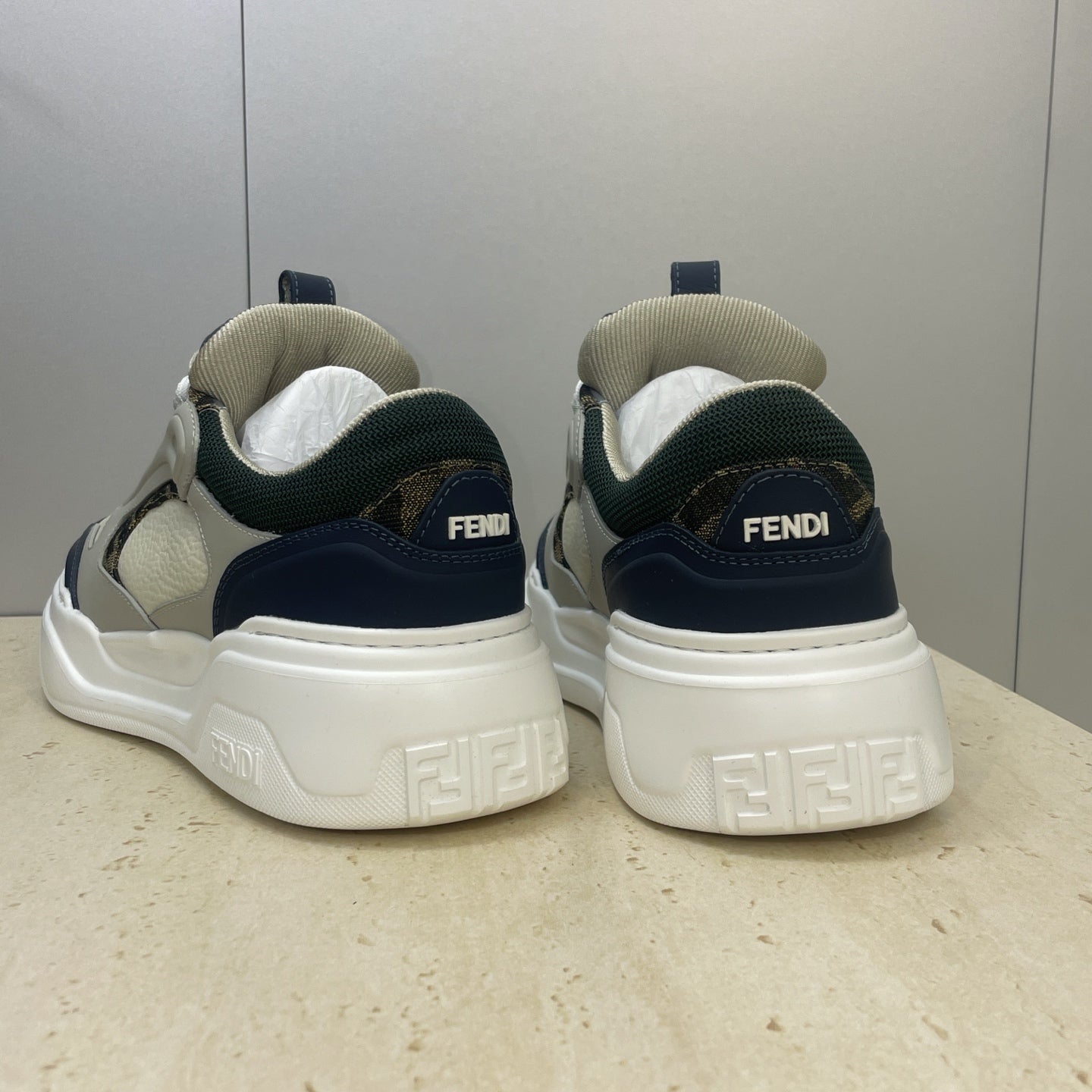 Fendi unisex sneakers heel view with FENDI branding, navy heel tabs, white sole