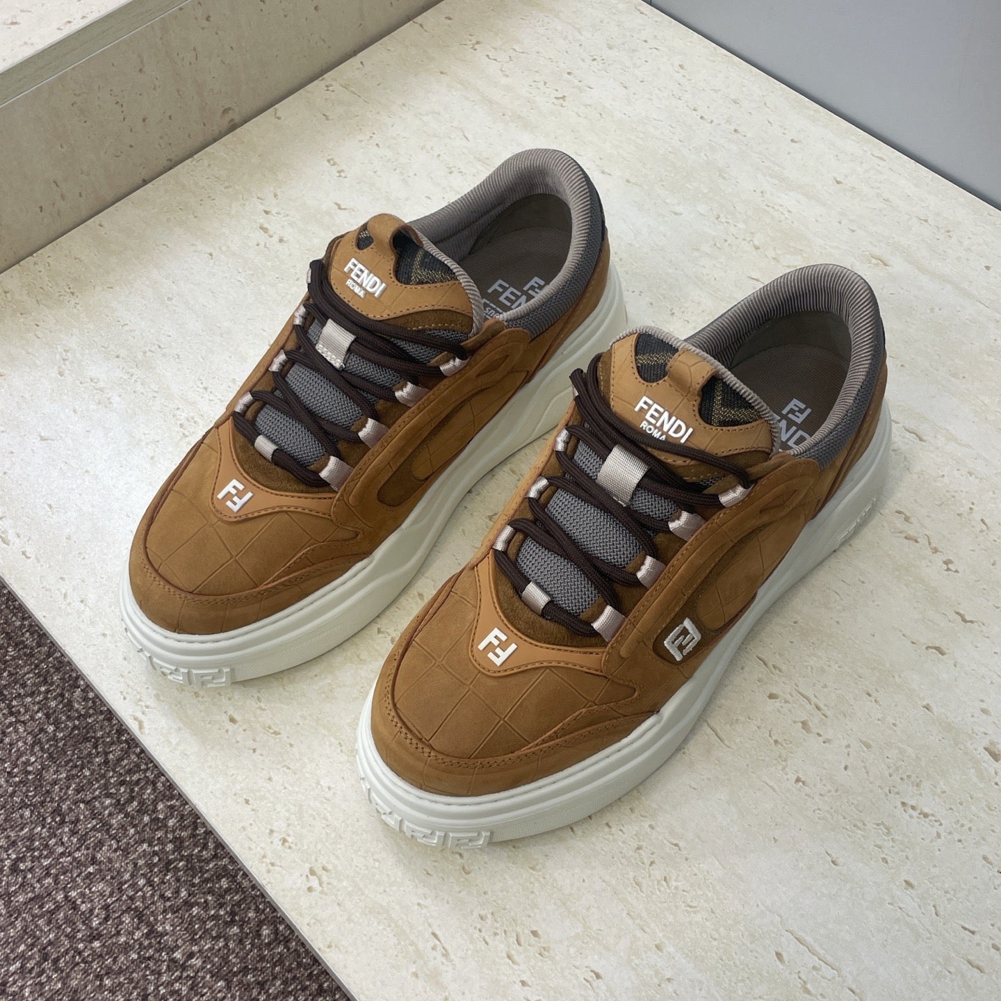 Tan Fendi unisex sneakers with gray lining, striped black-and-white lace details