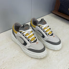 Fendi unisex sneakers pair, light gray leather with white laces, yellow accents, black inserts