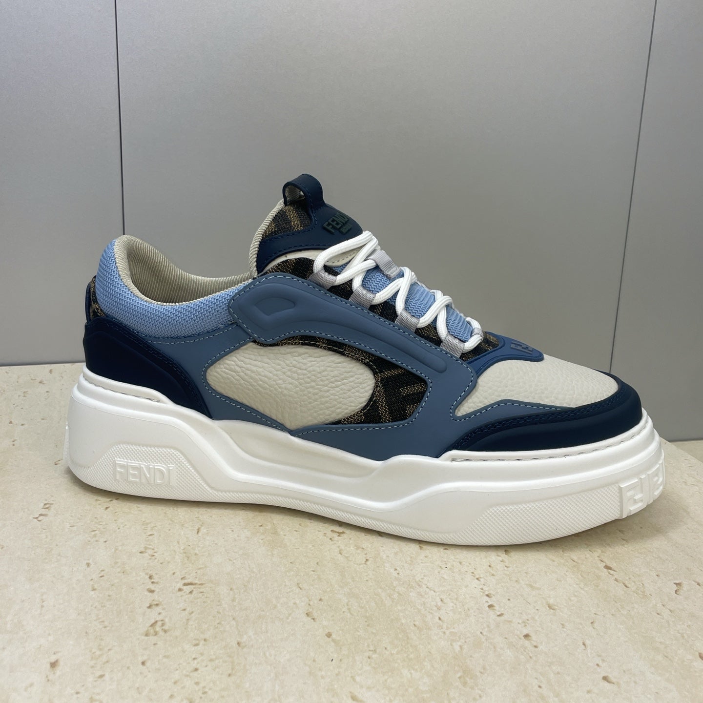 Fendi unisex sneakers angled, light blue collar and uppers, navy trim, white midsole