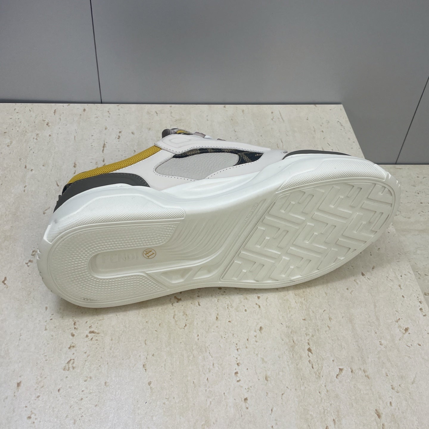 Fendi unisex sneakers outsole, white rubber sole with tread and yellow upper accents
