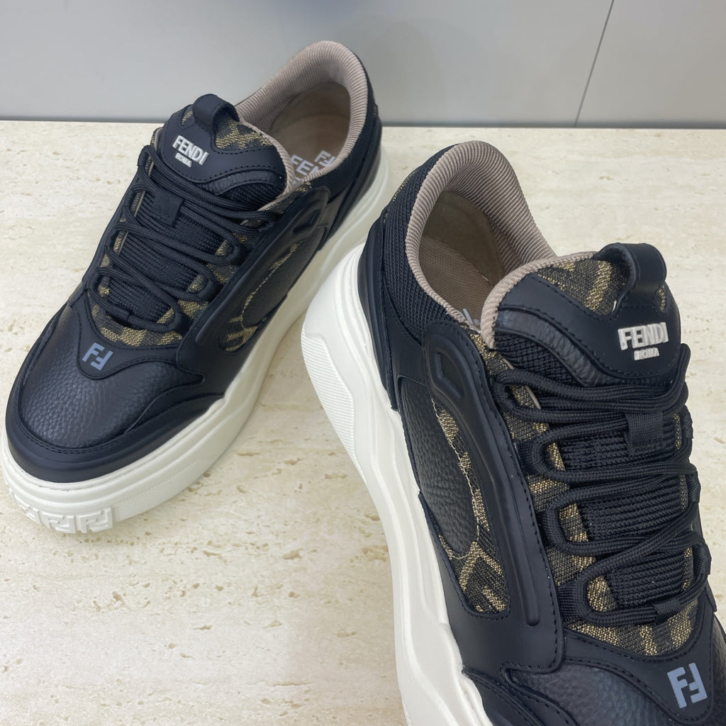 Fendi unisex sneakers close-up: dark navy leather with gold logo trim, thick white sole