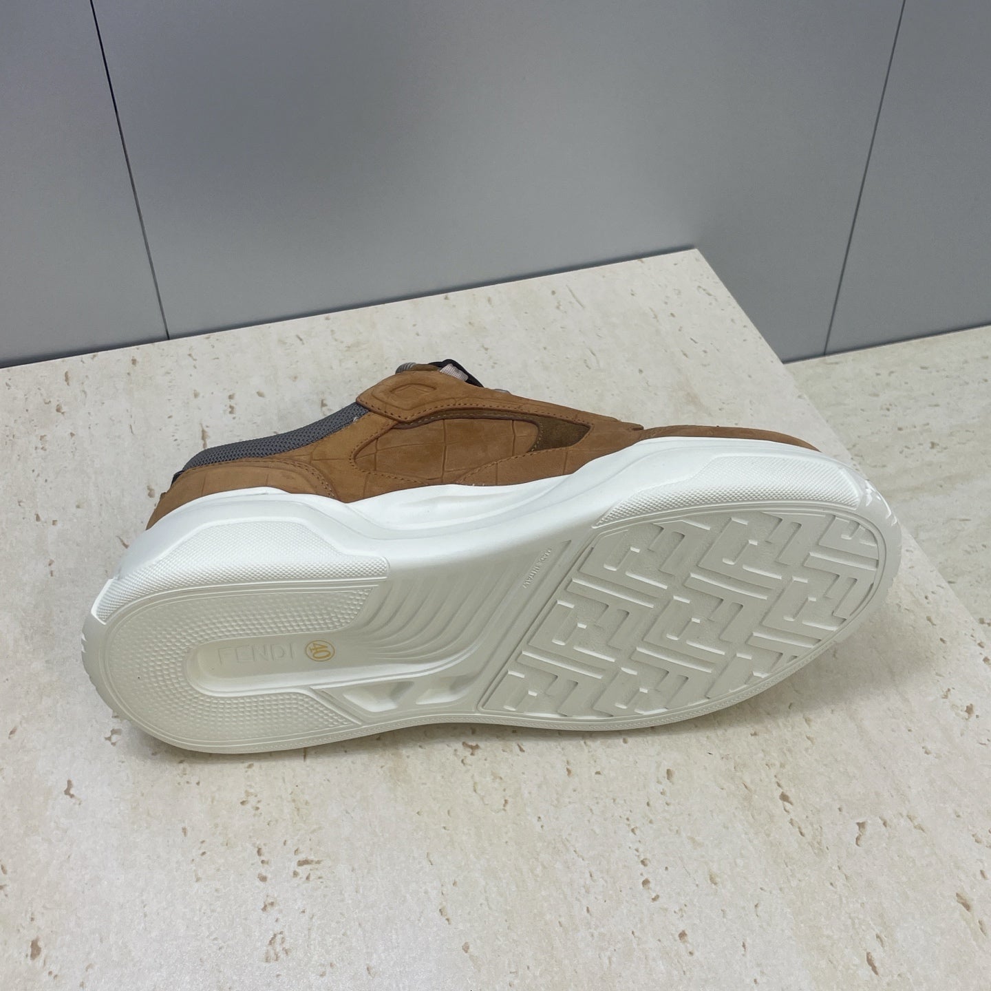 Tan Fendi unisex sneaker outsole view with white tread and gray heel panel