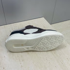 Unisex sneaker outsole view, textured tread on cream rubber sole
