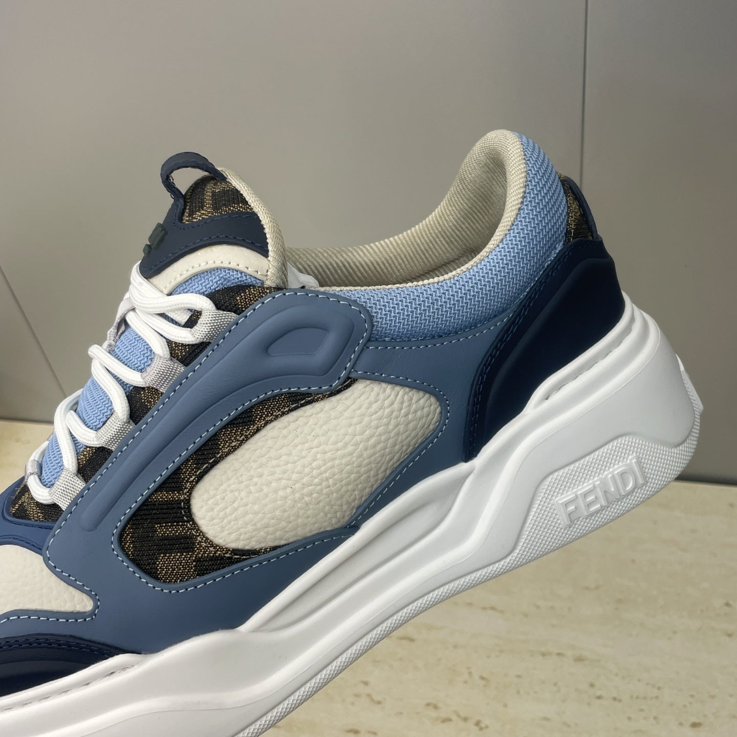 Fendi unisex sneakers detail, navy strap, cream panel, light blue laces, white sole
