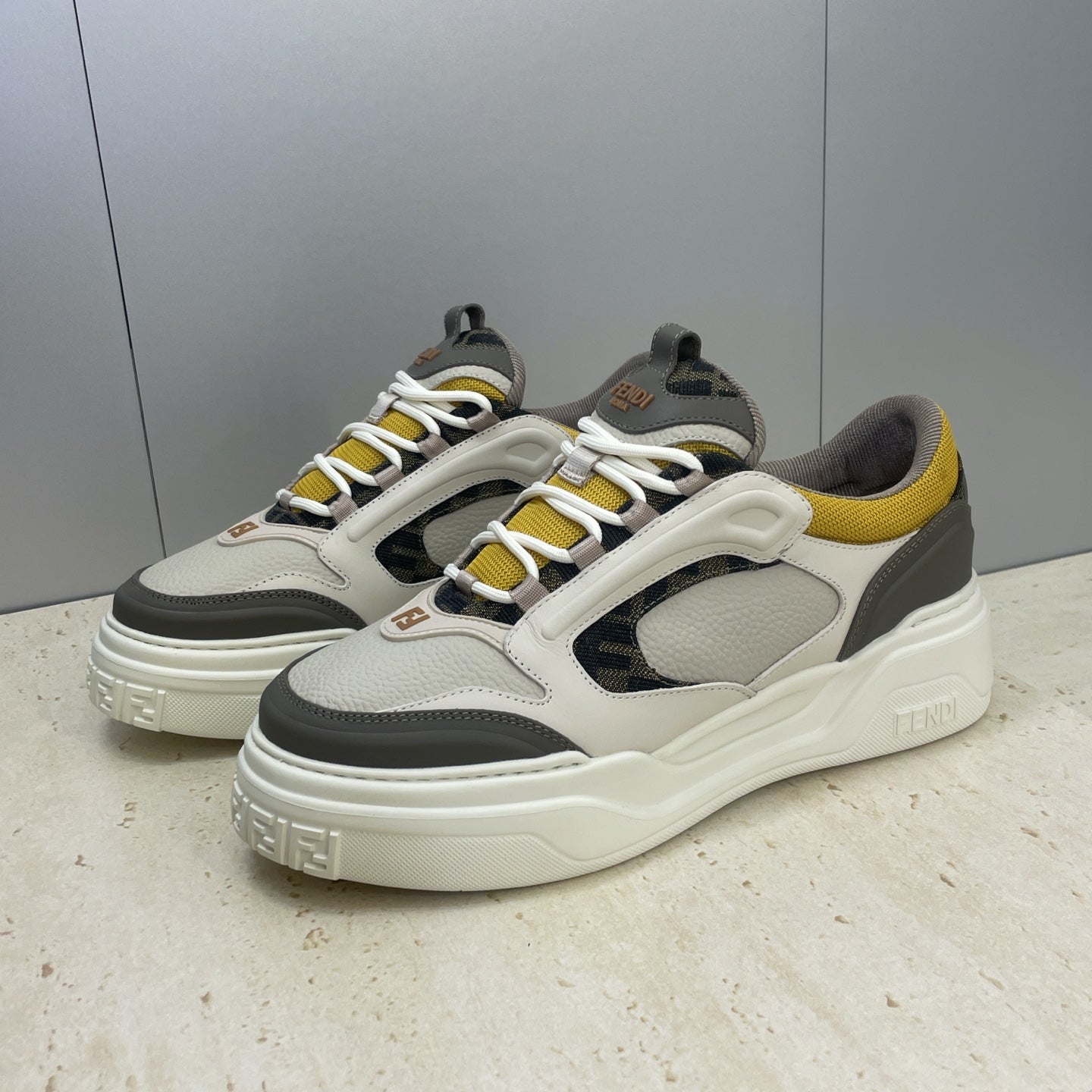 Fendi unisex sneakers, cream-white rubber sole with white laces, yellow and dark gray accents