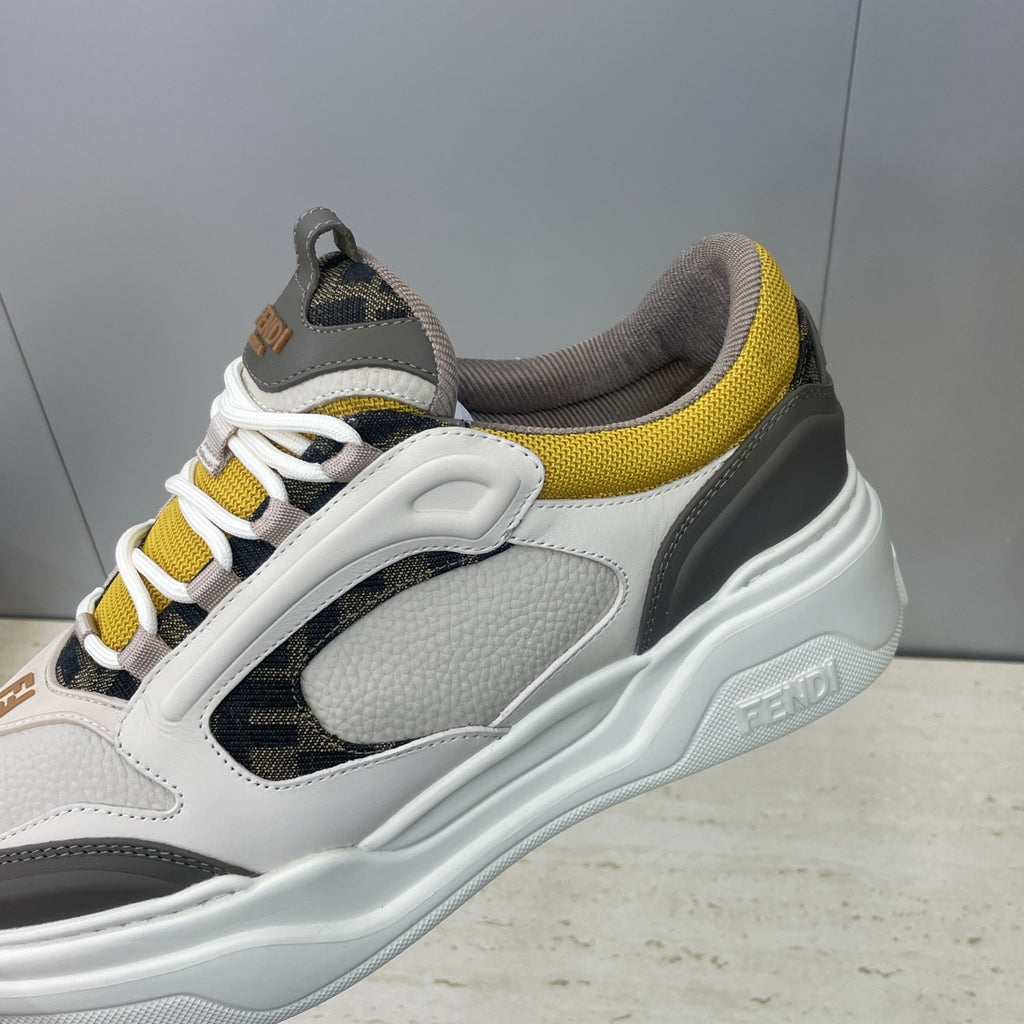 Fendi unisex sneakers close-up, white leather with black stripe and yellow collar detail