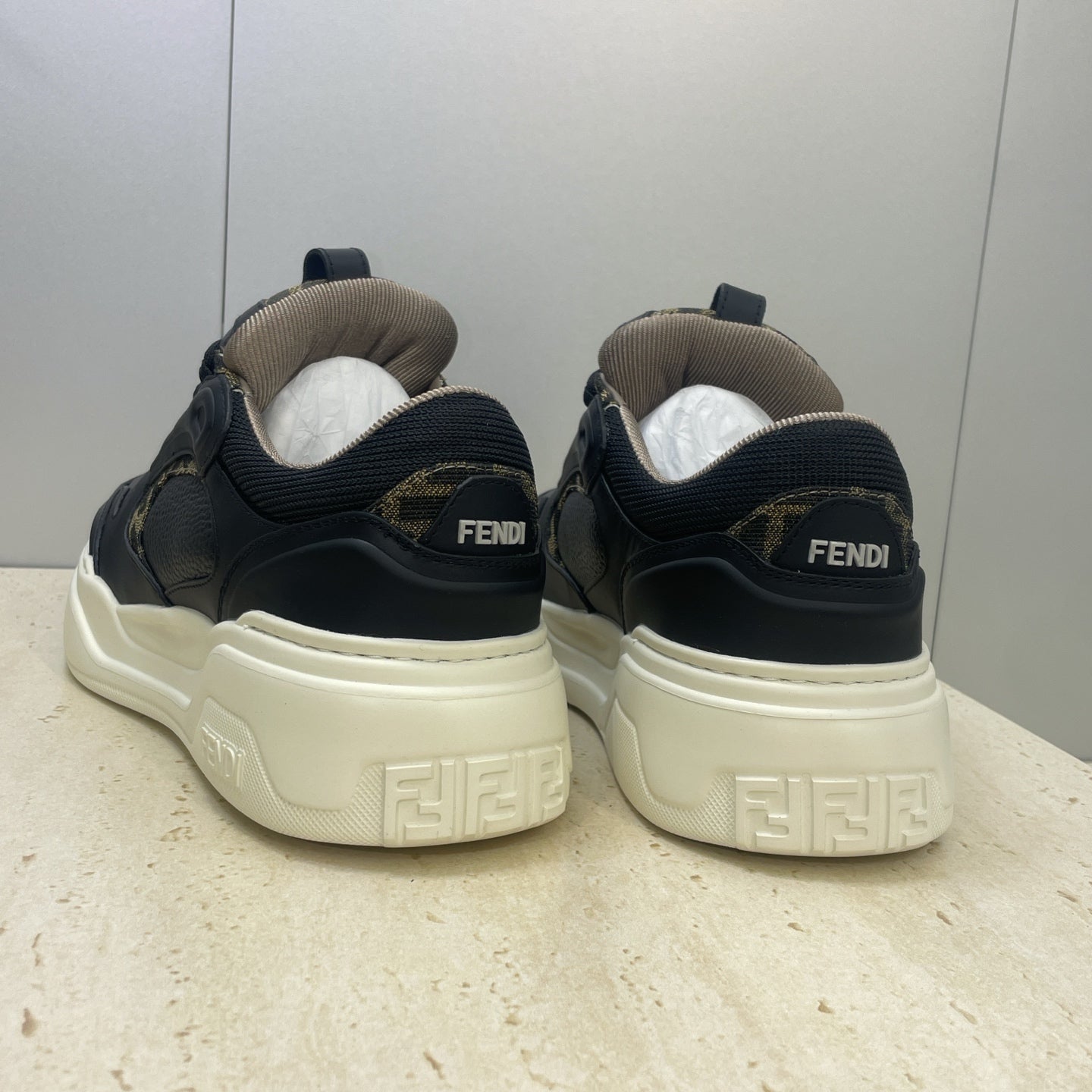 Fendi unisex sneakers back view: navy uppers with Fendi heel branding, cream sole
