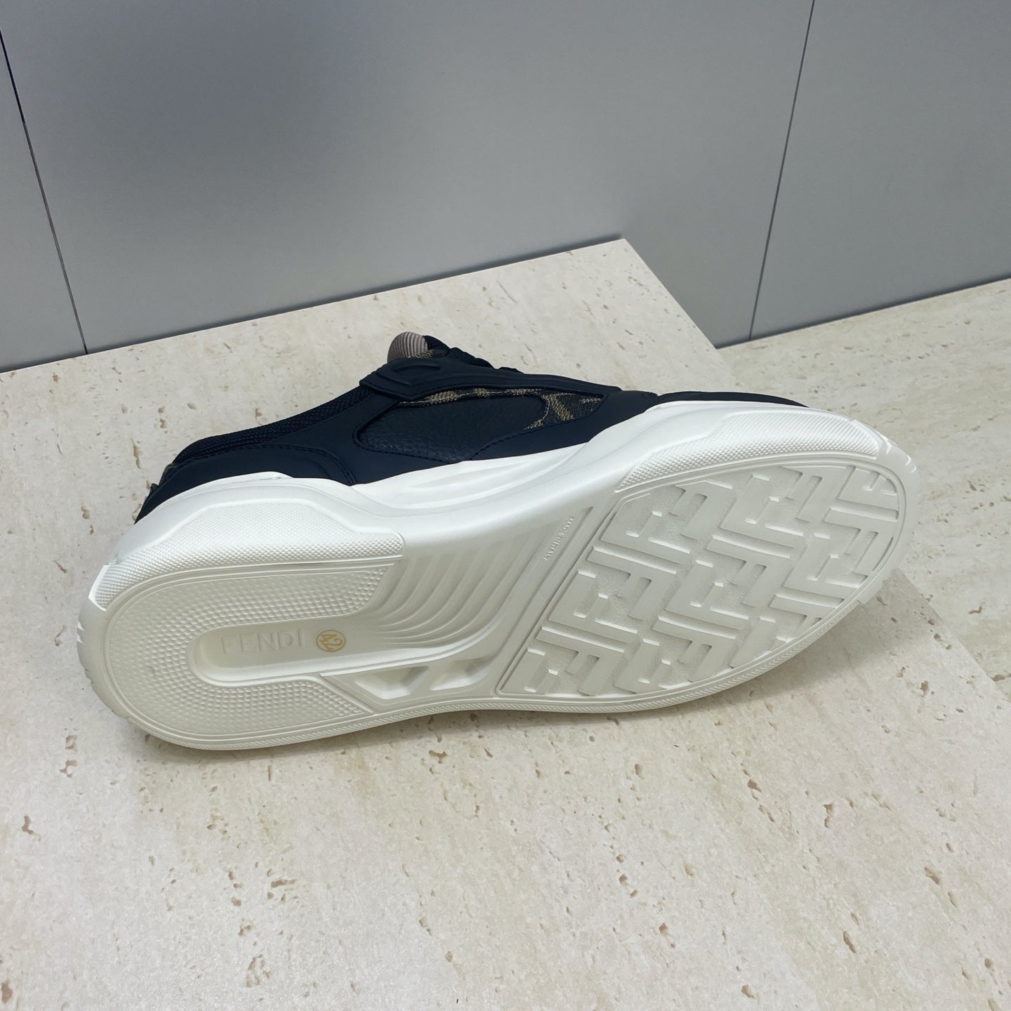 Fendi unisex sneakers outsole view, treaded white rubber sole and navy upper