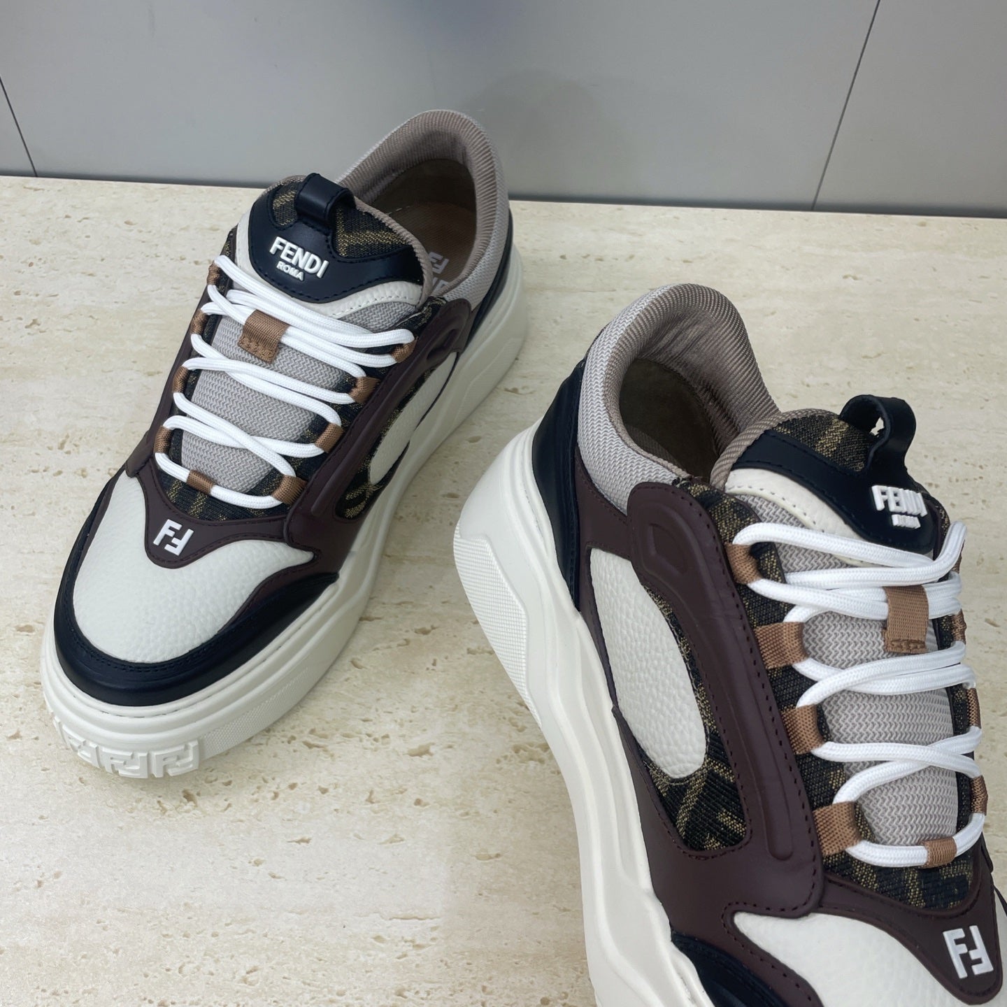 Unisex sneakers close side, white laces with dark brown leather and navy toe cap