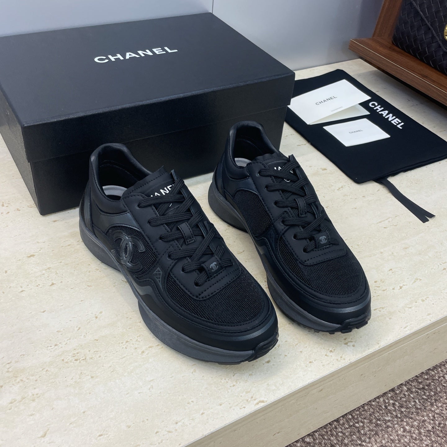 Chanel unisex low-top sneakers in dark fabric with CC logo detail and lace-up front