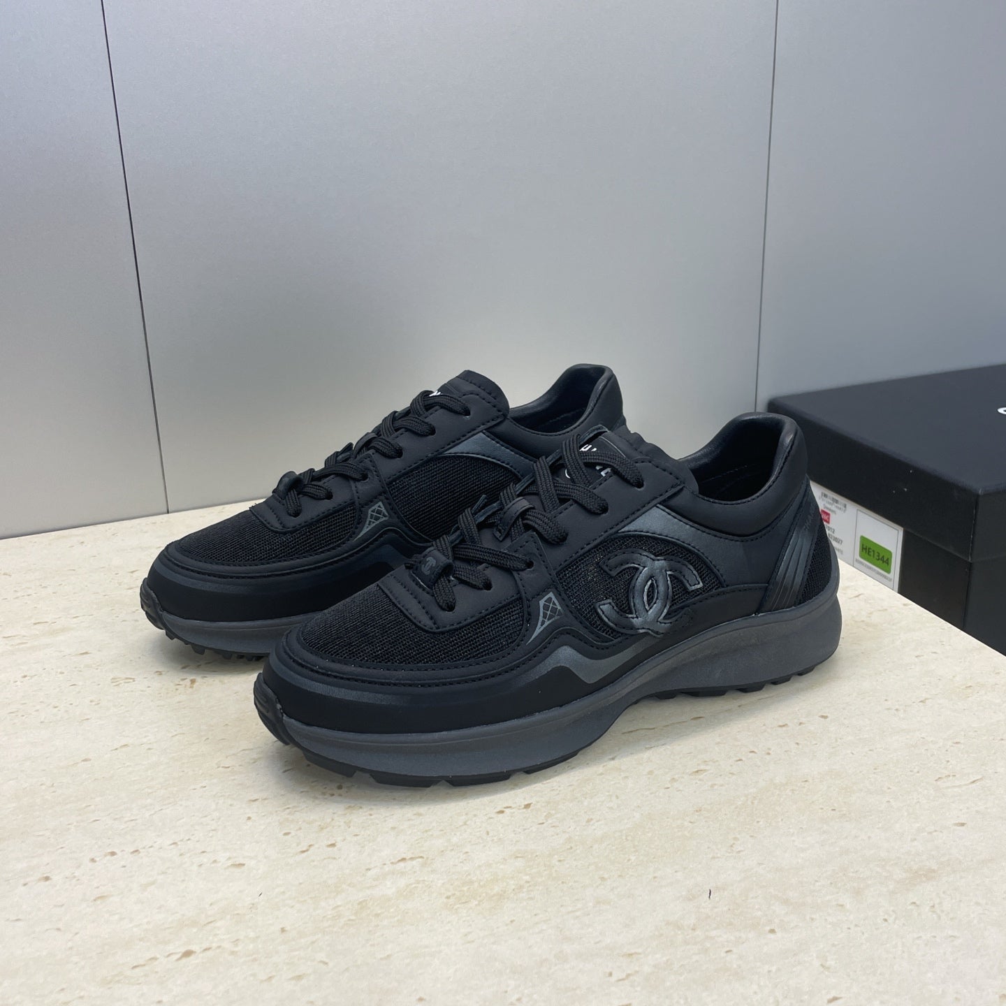 Chanel unisex low-top sneakers in dark mesh with raised CC emblem and lace-up