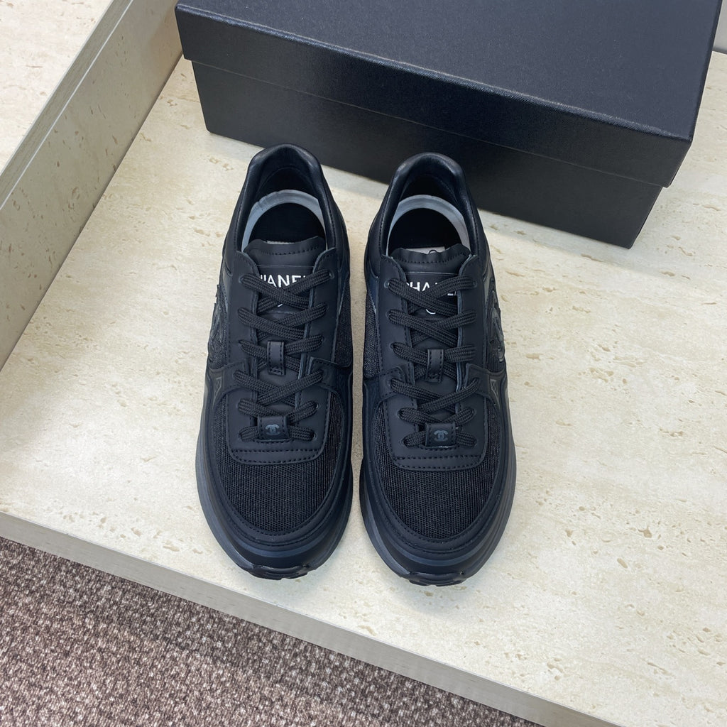 Chanel unisex low-top sneakers, dark upper with lace-up closure and cushioned sole