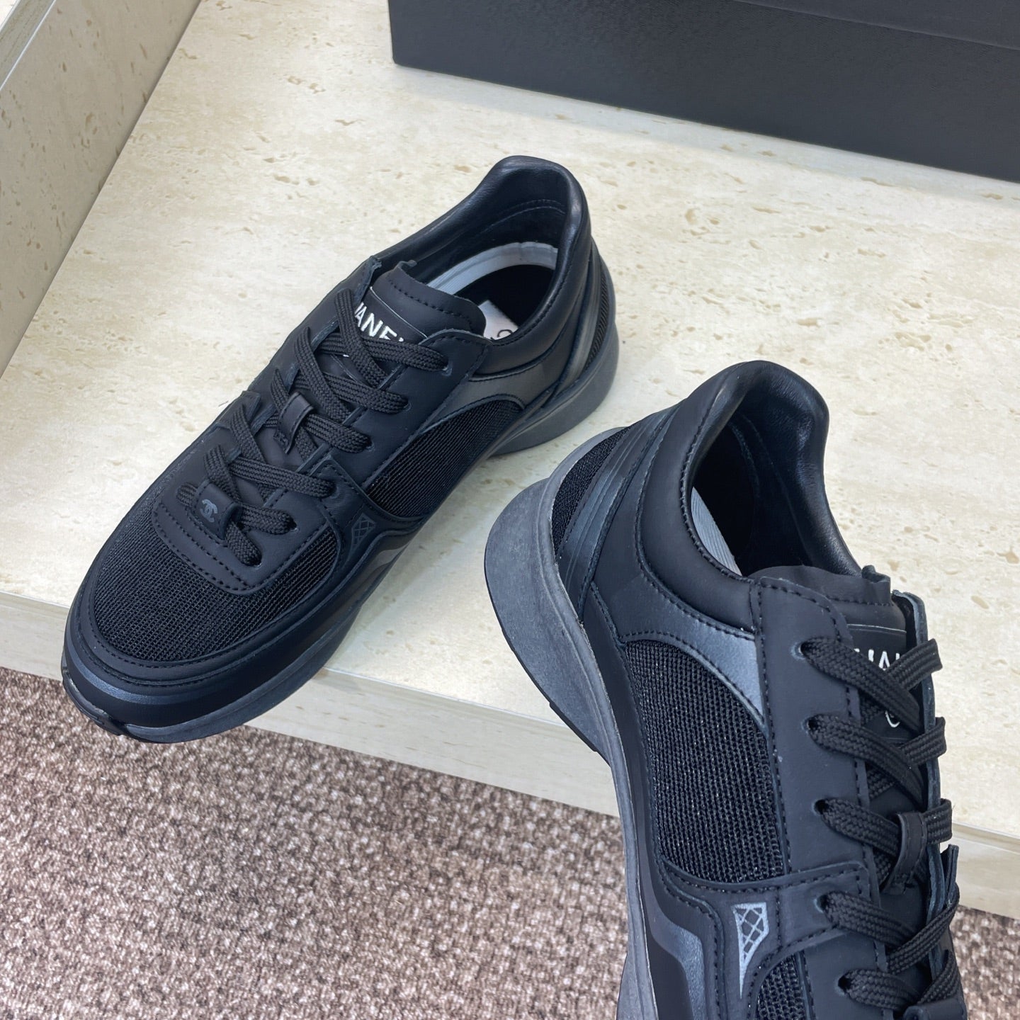 Chanel unisex low-top sneakers with dark mesh and leather panels, lace-up design