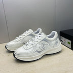 White Chanel unisex lace-up sneakers, pair on display with side emblem