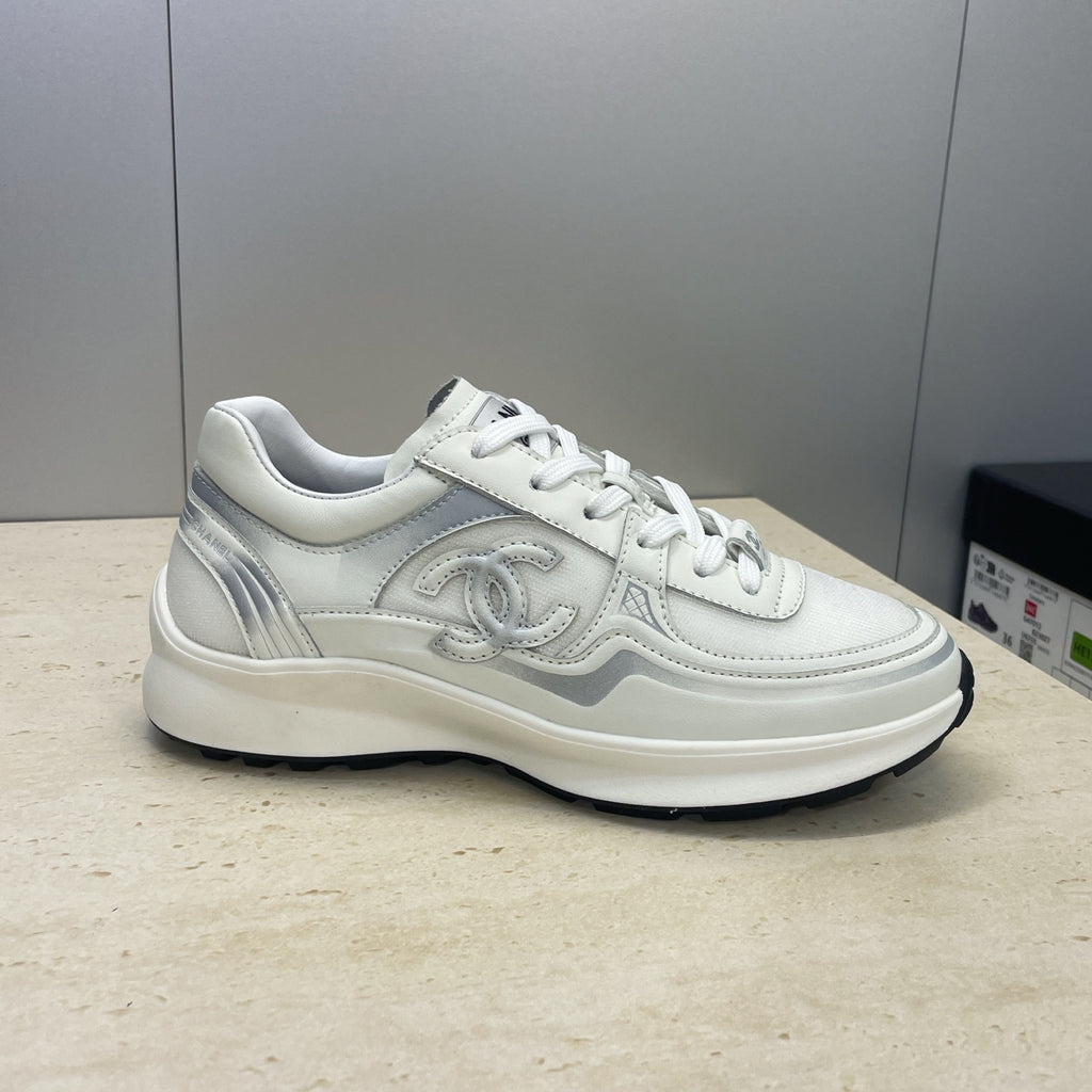 White Chanel unisex lace-up sneakers, side profile with logo detailing