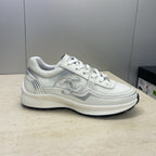 White Chanel unisex lace-up sneakers, side profile with logo detailing