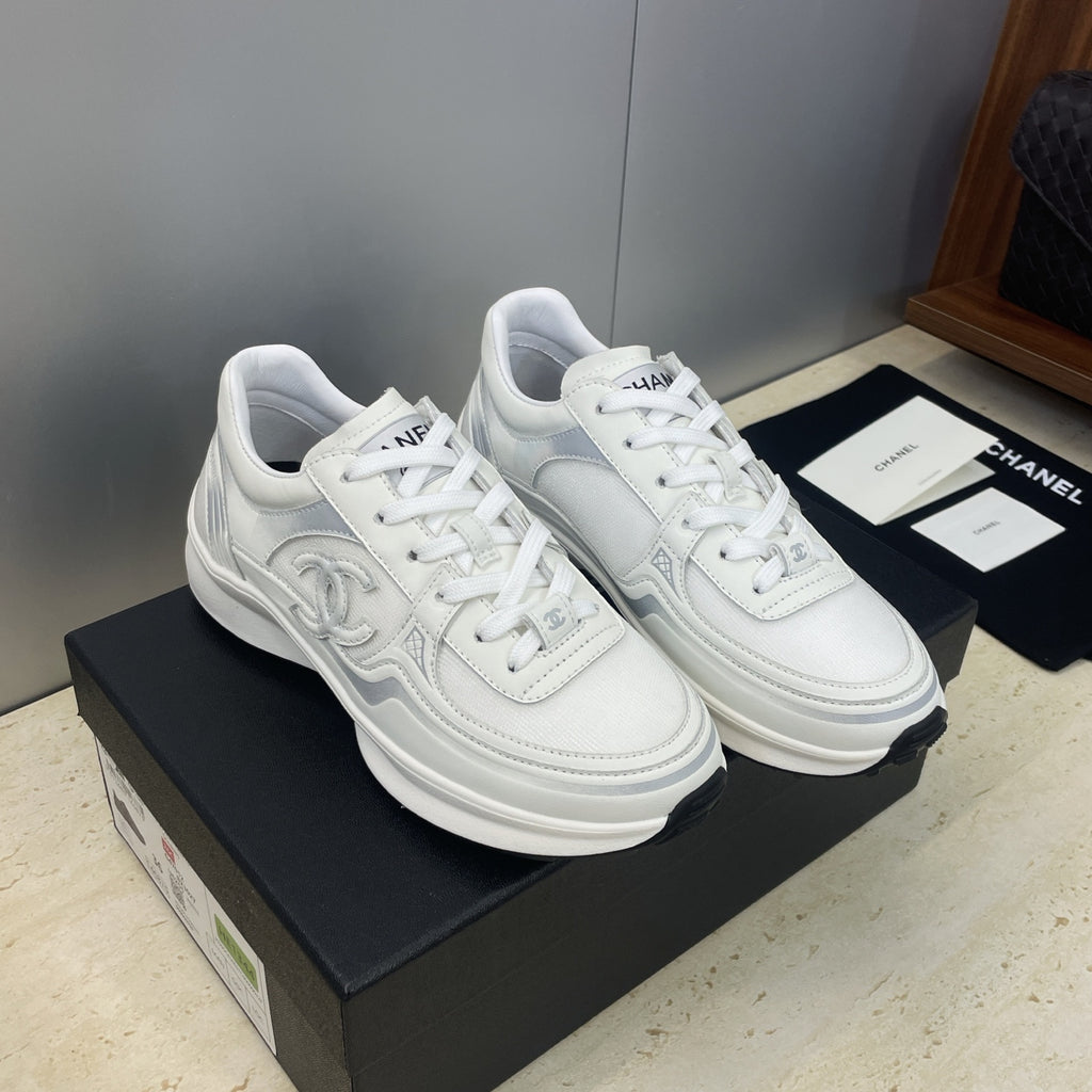 White Chanel unisex lace-up sneakers, front three-quarter view
