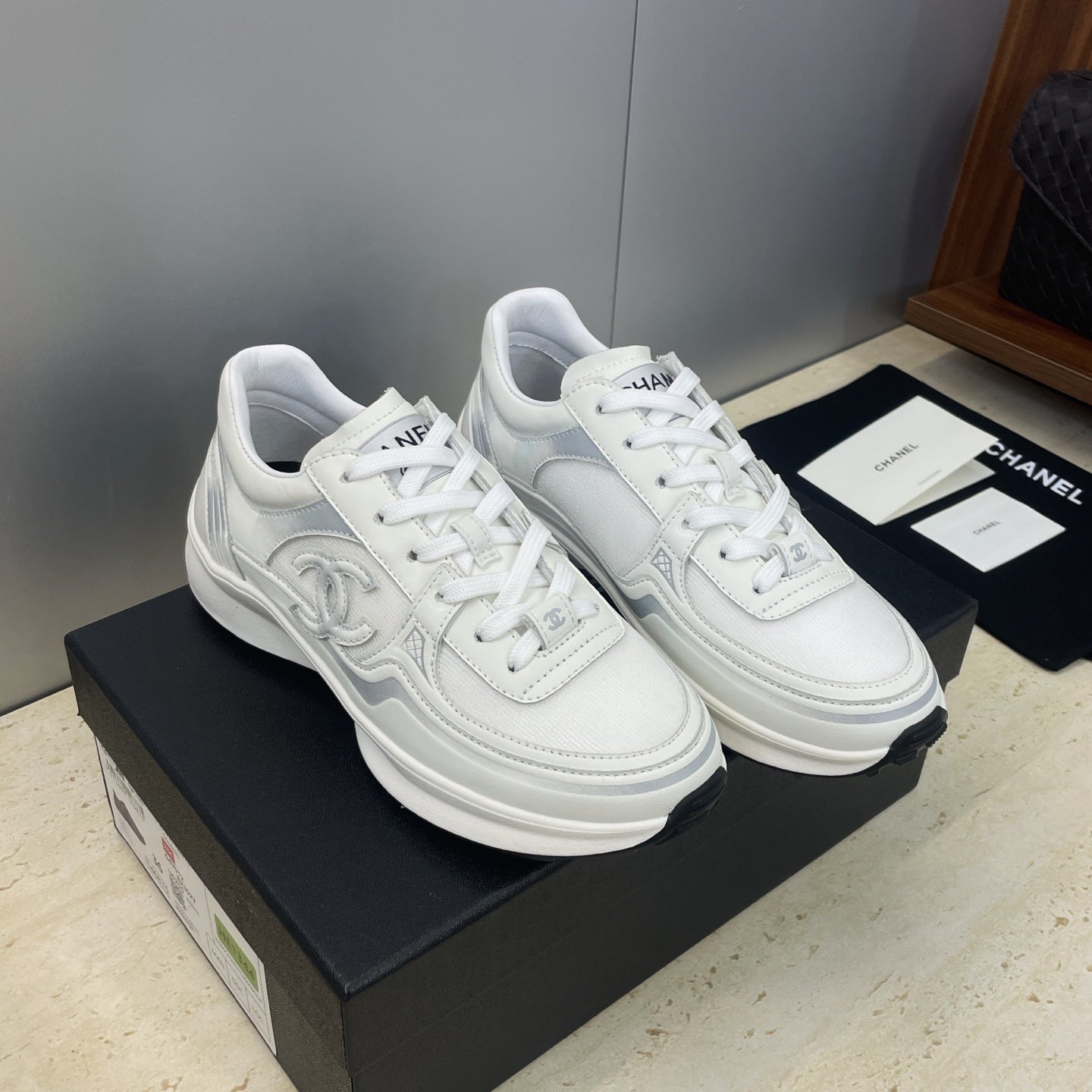 White Chanel unisex lace-up sneakers, front three-quarter view