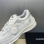White Chanel unisex lace-up sneakers, close-up of side emblem and laces