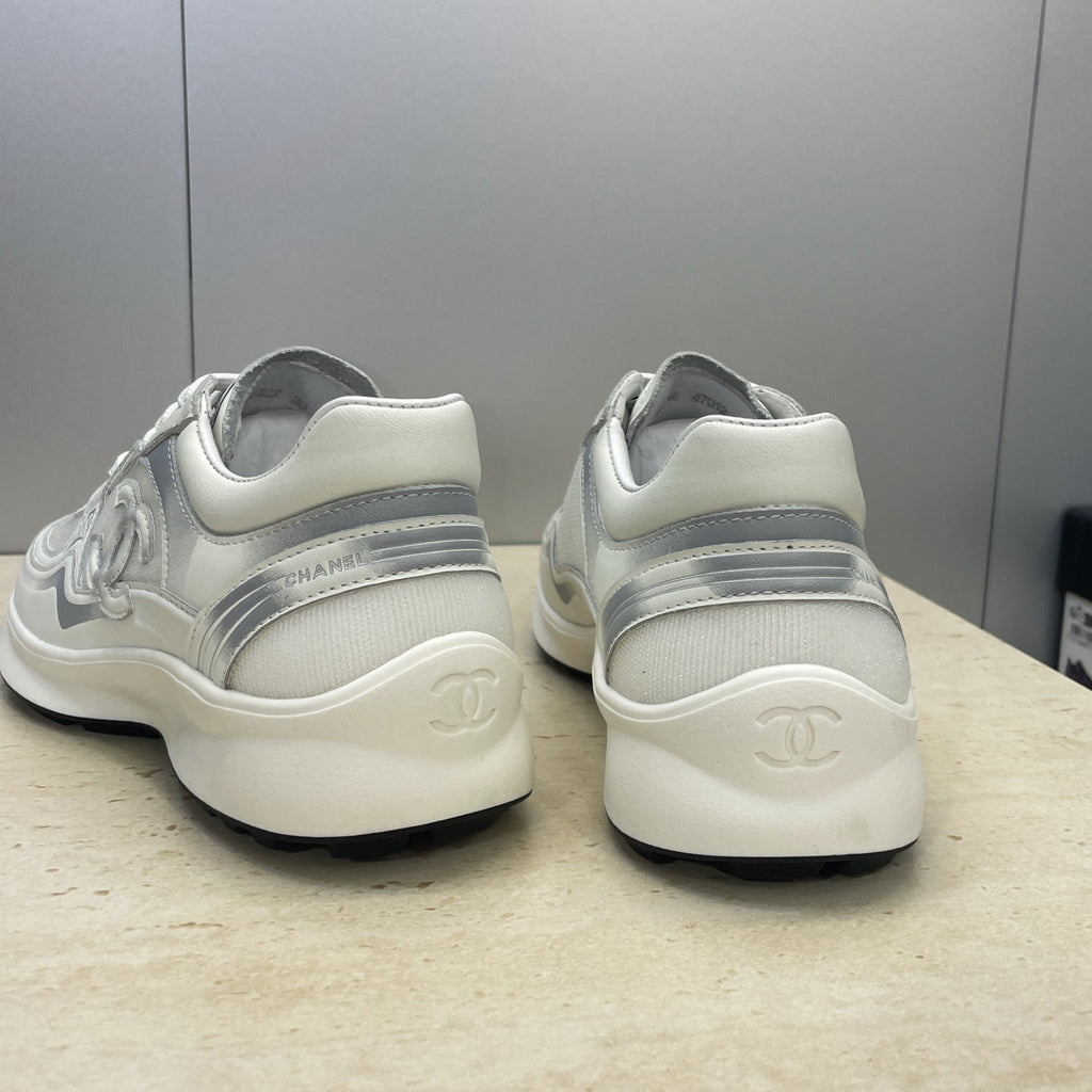 White Chanel unisex sneakers, heel view with logo embossing on back