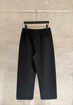 Black wide-leg pants with elastic drawstring waist and front right patch pocket