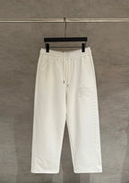 White cropped pants with elastic waistband and side seam detailing