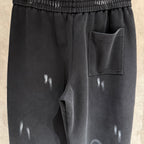 Black wide-leg pants with side pocket and glossy marks