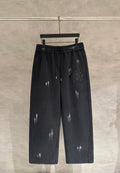 Dark pants, elastic waistband and drawstring, glossy splash print, decorative patch