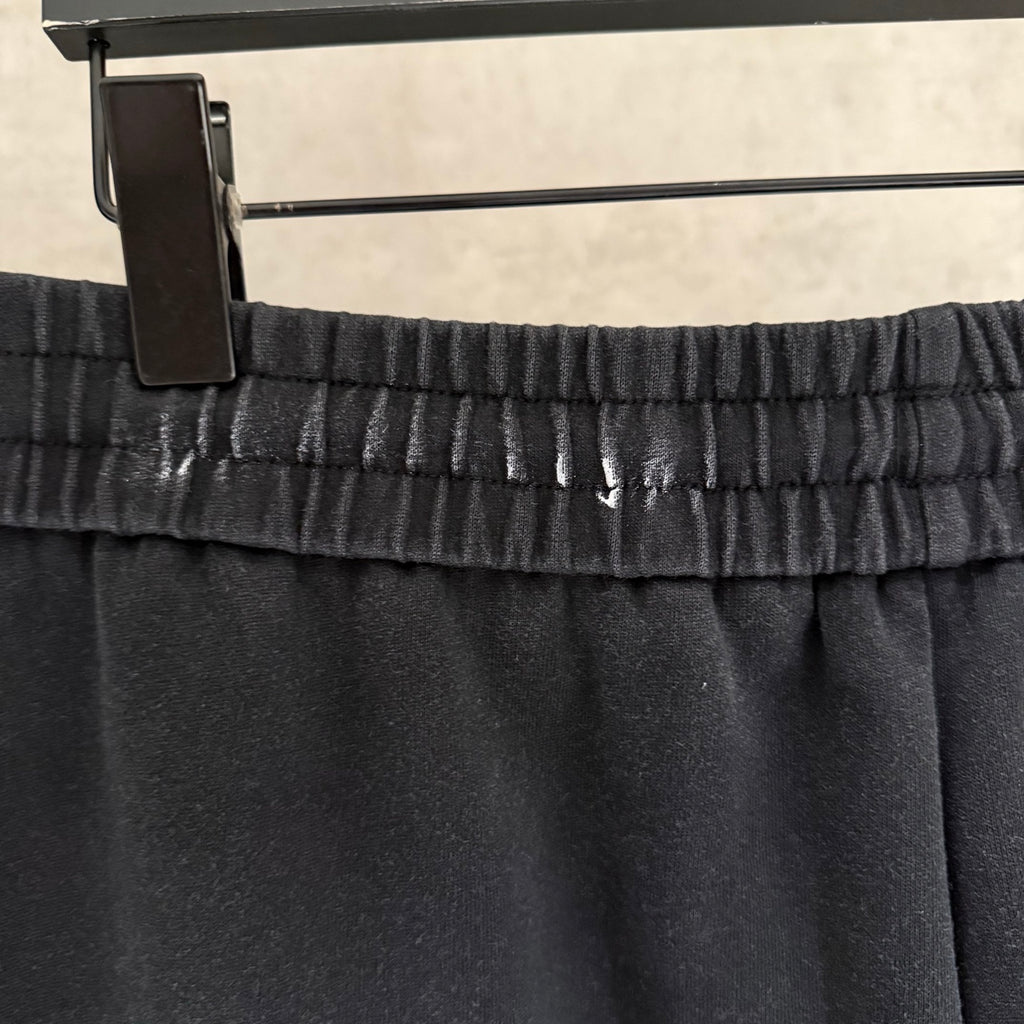 Dark pants waistband with elastic band and drawstring, glossy sheen