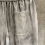 Light gray Chrome pants close-up: front patch pocket and elastic waistband