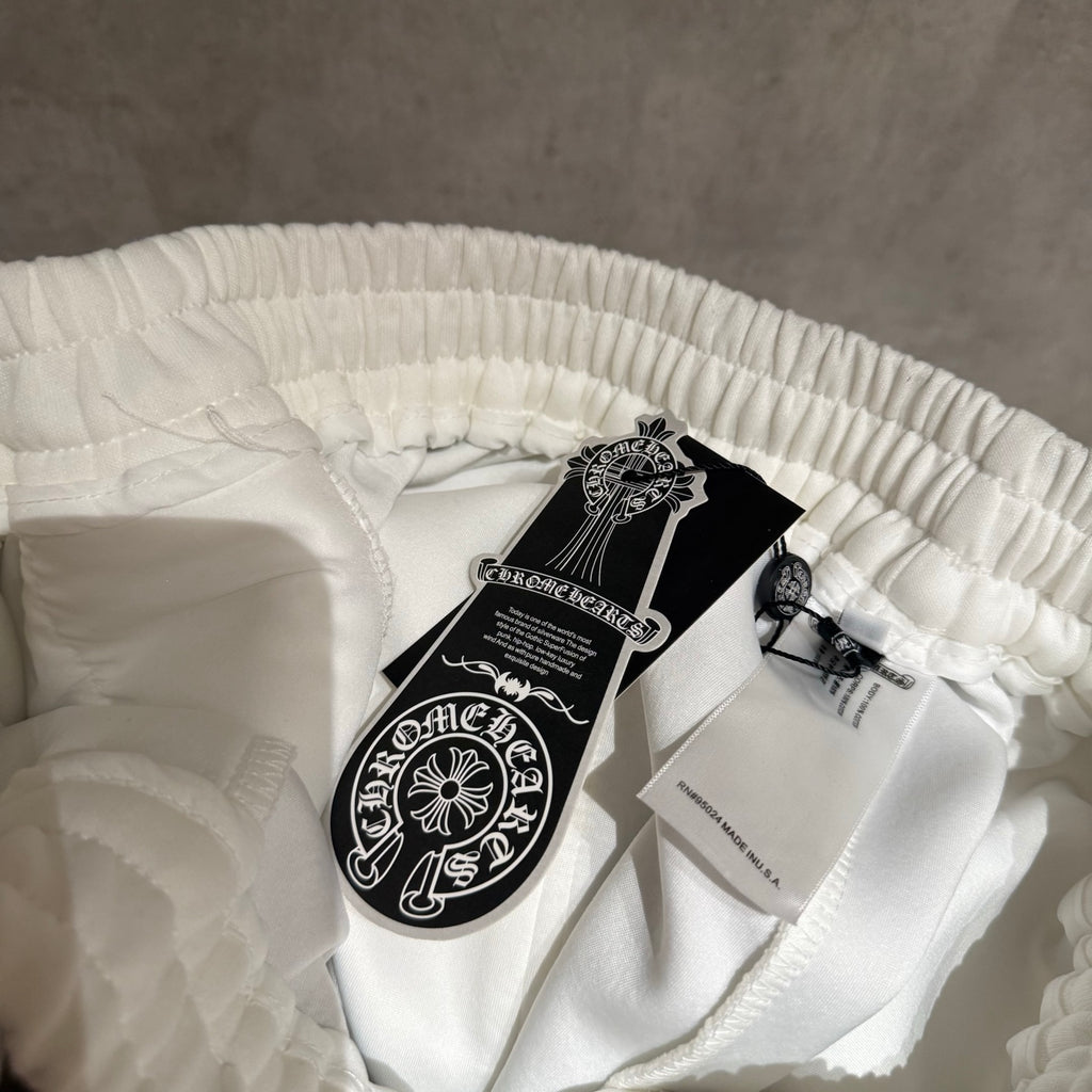 White Chrome pants folded with elastic waistband and product tag